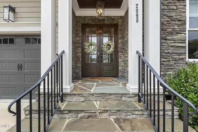 2098 Amalfi Pl, Apex, NC 27502 - entrance to property with stone siding, french doors, covered porch, and a garage