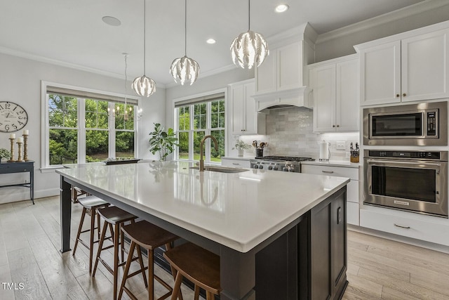 2098 Amalfi Pl, Apex, NC 27502 - kitchen with stainless steel appliances, a chandelier, ornamental molding, light countertops, and tasteful backsplash