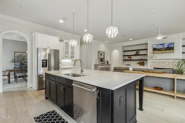 2098 Amalfi Pl, Apex, NC 27502 - kitchen with appliances with stainless steel finishes, dark cabinets, white cabinetry, ornamental molding, and light wood finished floors