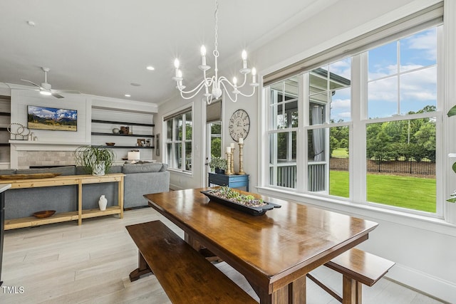 2098 Amalfi Pl, Apex, NC 27502 - dining room featuring light wood-style flooring, a chandelier, crown molding, ceiling fan, and recessed lighting
