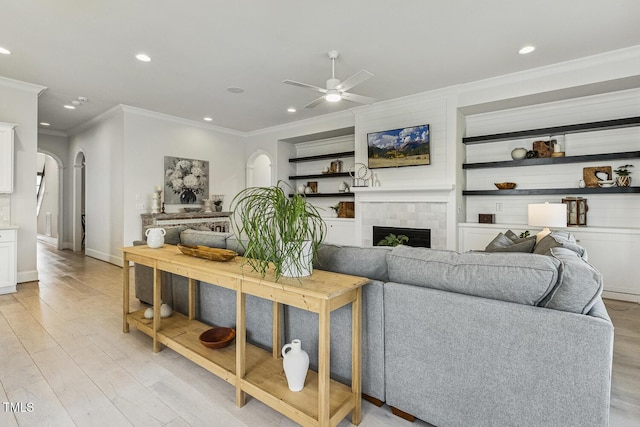 2098 Amalfi Pl, Apex, NC 27502 - living area featuring arched walkways, crown molding, recessed lighting, light wood finished floors, and a ceiling fan