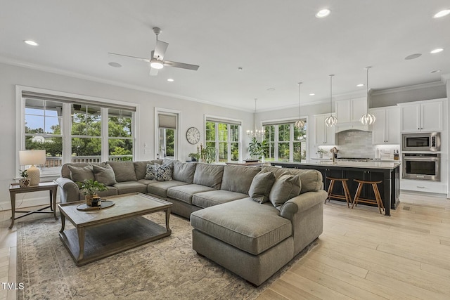 2098 Amalfi Pl, Apex, NC 27502 - living room featuring recessed lighting, light wood-style flooring, ceiling fan, and crown molding