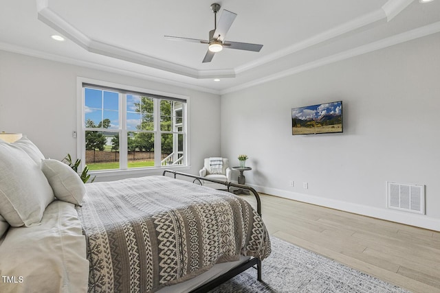 2098 Amalfi Pl, Apex, NC 27502 - bedroom featuring a tray ceiling, ornamental molding, wood finished floors, recessed lighting, and a ceiling fan