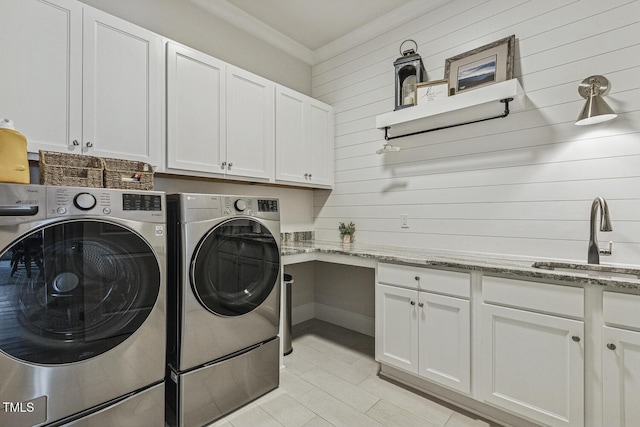 2098 Amalfi Pl, Apex, NC 27502 - laundry room with washing machine and clothes dryer, cabinet space, wood walls, and light tile patterned flooring