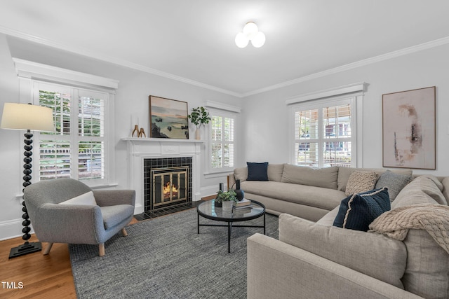 1015 W Trinity Ave, Durham, NC 27701 - living room featuring crown molding, wood finished floors, and a tile fireplace