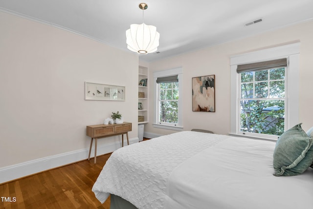 1015 W Trinity Ave, Durham, NC 27701 - bedroom with dark wood-type flooring and crown molding