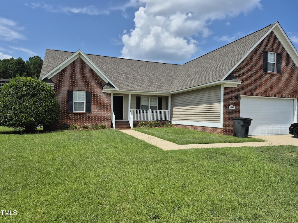 5908 Gentleman Dr, Hope Mills, NC 28348 - traditional home with a porch, brick siding, a shingled roof, a front yard, and driveway