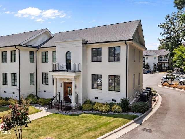 607 Smedes Pl Unit A, Raleigh, NC 27605 - view of front of house with crawl space, a balcony, a shingled roof, and a front yard