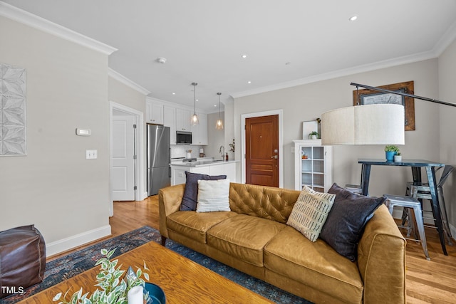 607 Smedes Pl Unit A, Raleigh, NC 27605 - living area featuring light wood-style flooring, ornamental molding, and recessed lighting
