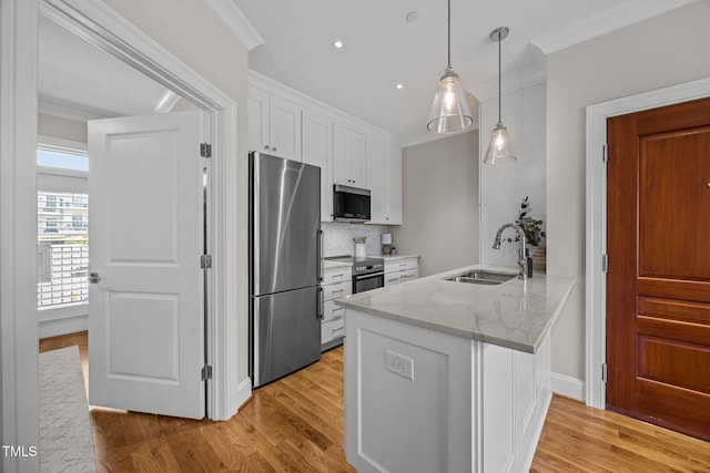 607 Smedes Pl Unit A, Raleigh, NC 27605 - kitchen featuring stainless steel appliances, white cabinetry, light stone counters, light wood-type flooring, and a peninsula
