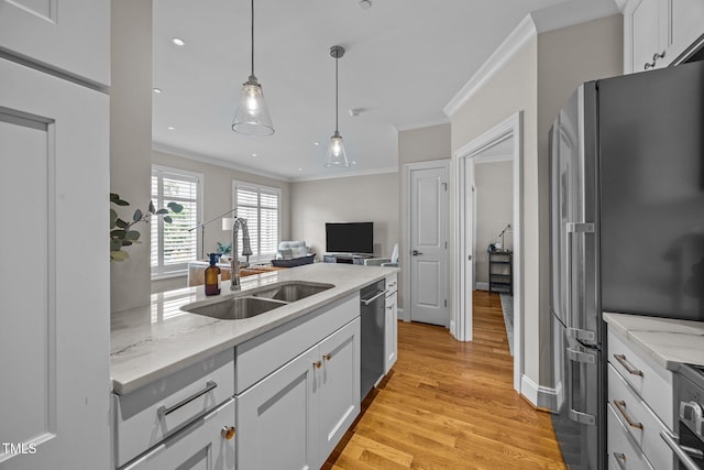 607 Smedes Pl Unit A, Raleigh, NC 27605 - kitchen with stainless steel appliances, ornamental molding, light wood-style flooring, white cabinetry, and light stone countertops