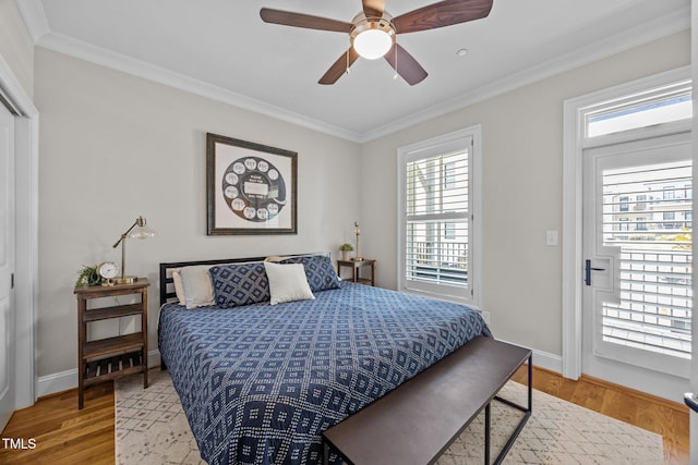 607 Smedes Pl Unit A, Raleigh, NC 27605 - bedroom with multiple windows, ornamental molding, light wood-style floors, and a ceiling fan