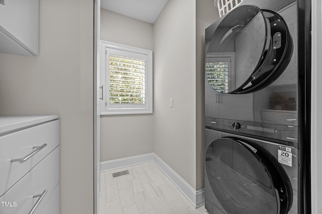 607 Smedes Pl Unit A, Raleigh, NC 27605 - washroom with stacked washer / dryer and plenty of natural light