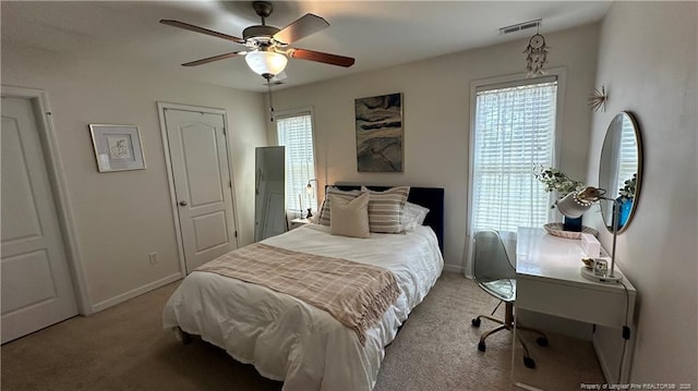 2133 Coinjock Cir, Fayetteville, NC 28304 - bedroom with light colored carpet, multiple windows, and a ceiling fan
