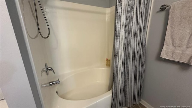 2133 Coinjock Cir, Fayetteville, NC 28304 - bathroom with shower / bathtub combination with curtain and baseboards