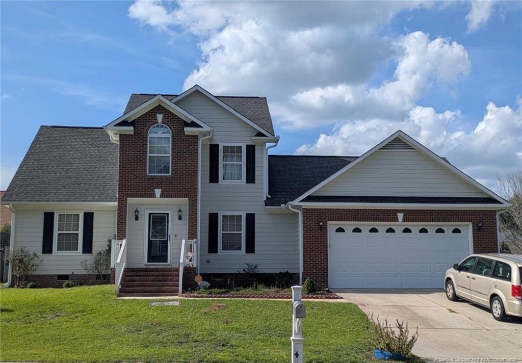 view of front of home featuring an attached garage, driveway, a front yard, and a shingled roof