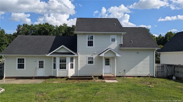 rear view of property featuring crawl space, roof with shingles, and a patio