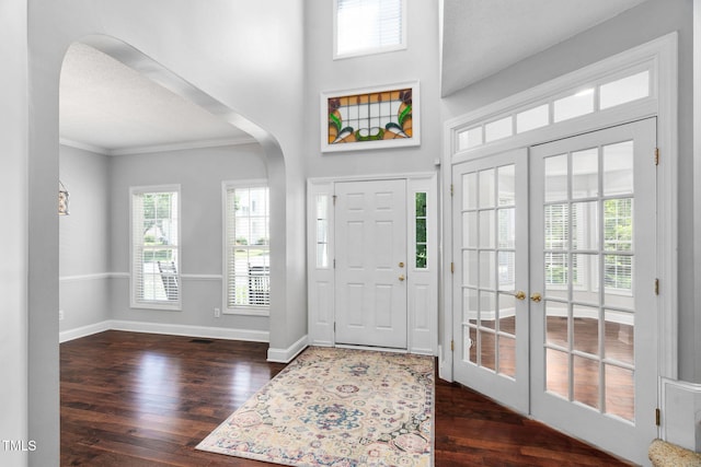 614 Park York Ln, Cary, NC 27519 - foyer featuring arched walkways, dark wood finished floors, ornamental molding, french doors, and a high ceiling