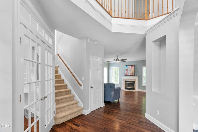 614 Park York Ln, Cary, NC 27519 - foyer entrance featuring dark wood finished floors, stairway, a fireplace with flush hearth, and ceiling fan