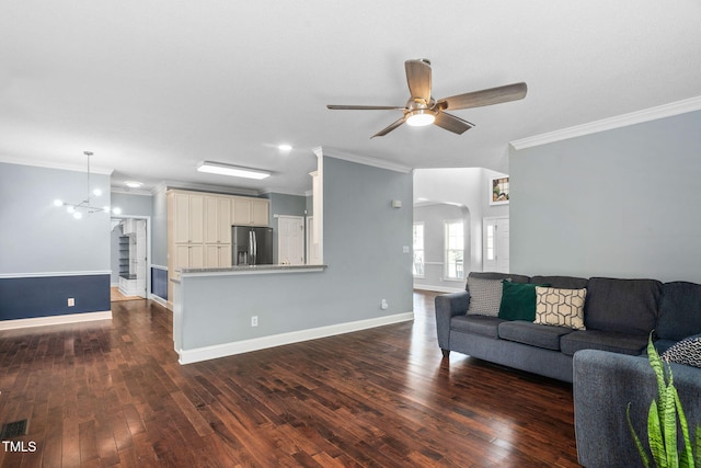 614 Park York Ln, Cary, NC 27519 - living room featuring ornamental molding, a ceiling fan, arched walkways, dark wood-type flooring, and a chandelier