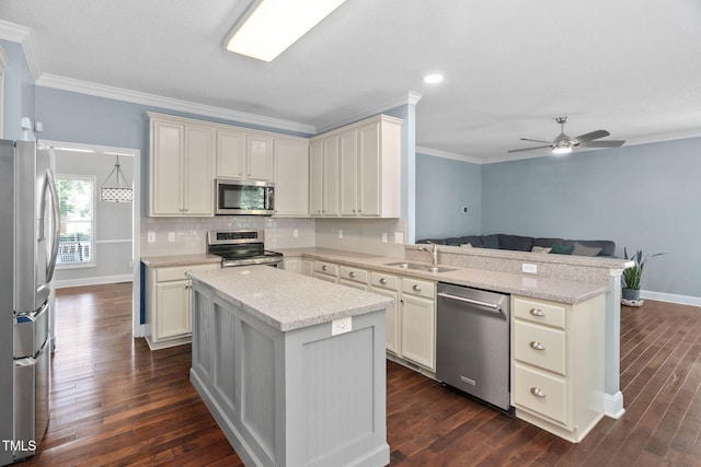 614 Park York Ln, Cary, NC 27519 - kitchen with stainless steel appliances, a peninsula, crown molding, dark wood-style floors, and open floor plan