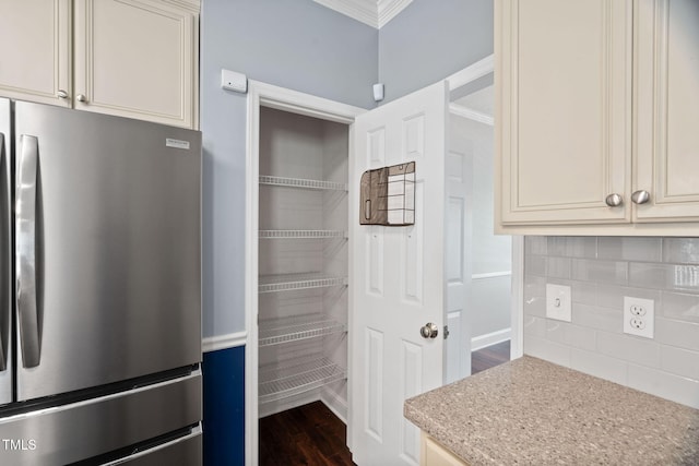 614 Park York Ln, Cary, NC 27519 - kitchen with freestanding refrigerator, crown molding, backsplash, cream cabinets, and dark wood finished floors