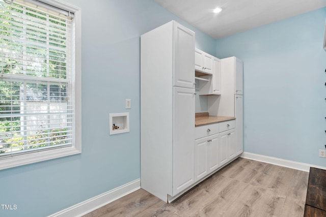 614 Park York Ln, Cary, NC 27519 - laundry room with hookup for a washing machine, light wood finished floors, and cabinet space
