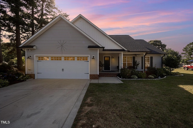 1405 Currituck Ave, Dunn, NC 28334 - view of front of home with driveway, an attached garage, a yard, and covered porch
