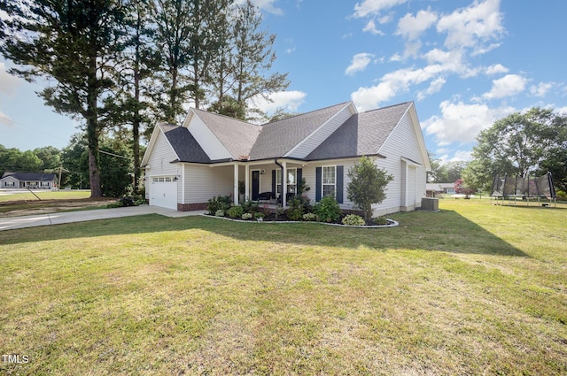 1405 Currituck Ave, Dunn, NC 28334 - view of front of home featuring a trampoline, an attached garage, concrete driveway, a front lawn, and a porch