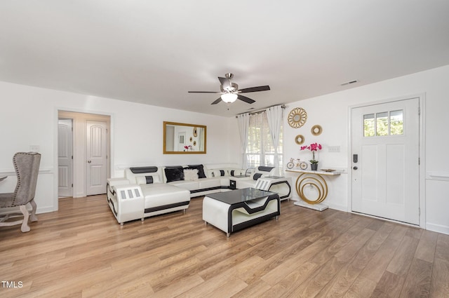 1405 Currituck Ave, Dunn, NC 28334 - living room featuring a ceiling fan, light wood finished floors, and healthy amount of natural light