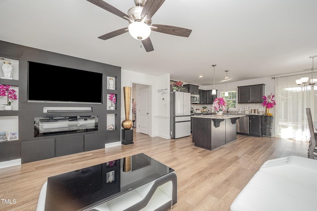 1405 Currituck Ave, Dunn, NC 28334 - living area featuring a ceiling fan, a chandelier, and light wood finished floors