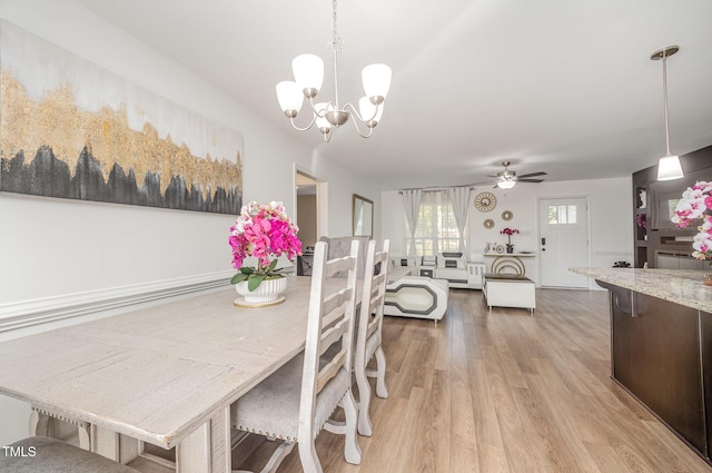 1405 Currituck Ave, Dunn, NC 28334 - dining area featuring a chandelier, light wood-style flooring, and a ceiling fan