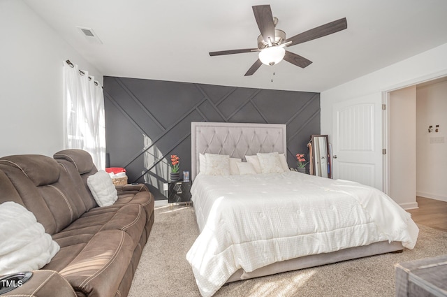 1405 Currituck Ave, Dunn, NC 28334 - carpeted bedroom featuring a decorative wall, a ceiling fan, and an accent wall