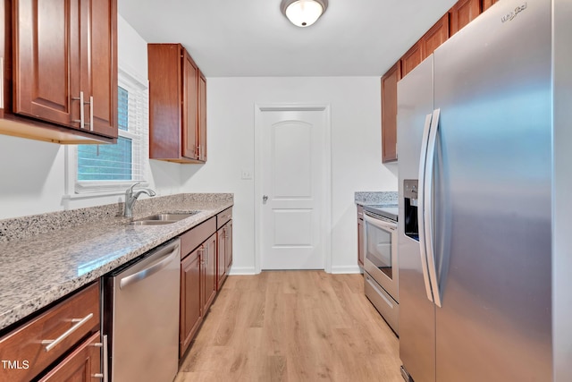 1804 Charles St, Raleigh, NC 27610 - kitchen with appliances with stainless steel finishes, light wood finished floors, light stone countertops, and brown cabinets