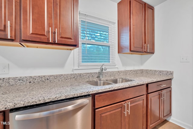 1804 Charles St, Raleigh, NC 27610 - kitchen with dishwasher, light stone countertops, and brown cabinetry