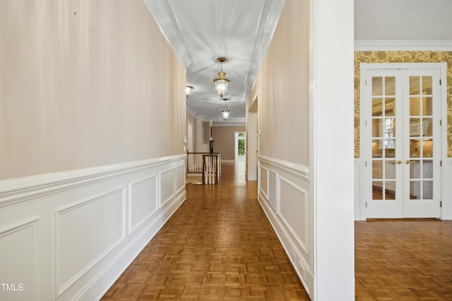 4137 Gardenlake Dr, Raleigh, NC 27612 - hallway with french doors, a decorative wall, ornamental molding, and wainscoting