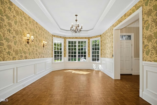 4137 Gardenlake Dr, Raleigh, NC 27612 - unfurnished dining area featuring a chandelier, wallpapered walls, a wainscoted wall, a tray ceiling, and ornamental molding