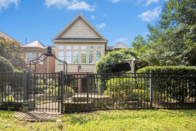 4137 Gardenlake Dr, Raleigh, NC 27612 - back of property featuring a standing seam roof, a gate, and a metal roof