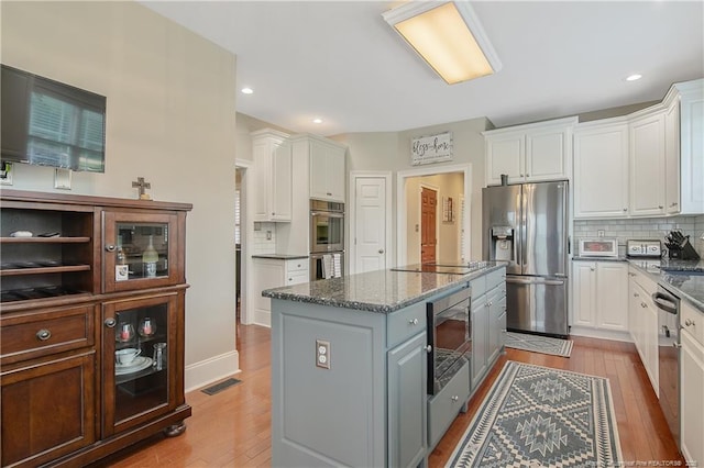9871 Ramsey St, Linden, NC 28356 - kitchen featuring appliances with stainless steel finishes, a center island, white cabinets, and recessed lighting