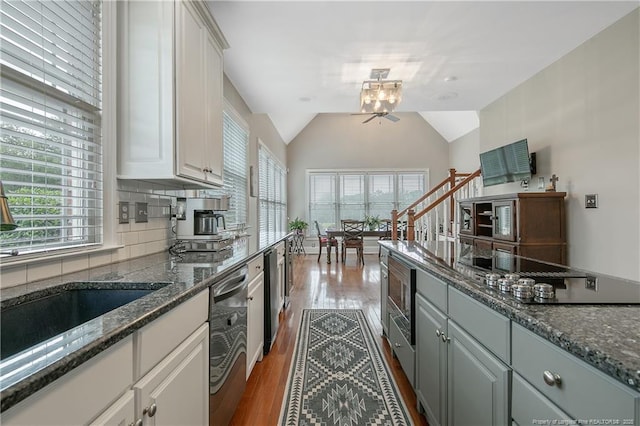 9871 Ramsey St, Linden, NC 28356 - kitchen featuring stainless steel appliances, dark wood-style floors, white cabinetry, decorative backsplash, and dark stone countertops