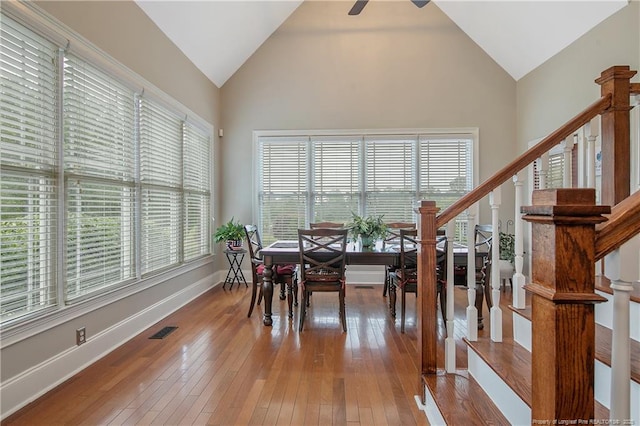 9871 Ramsey St, Linden, NC 28356 - dining space with hardwood / wood-style floors, high vaulted ceiling, stairway, and ceiling fan