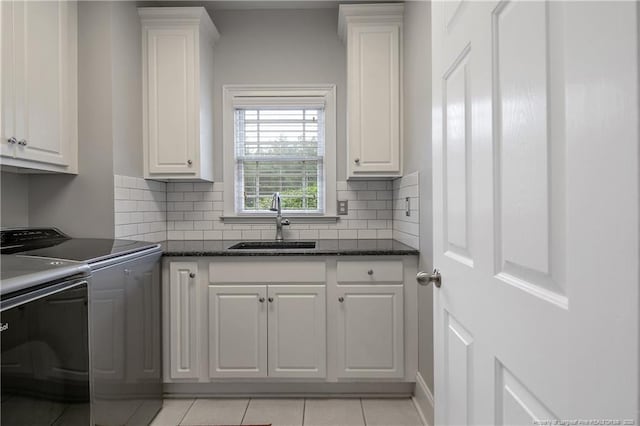 9871 Ramsey St, Linden, NC 28356 - kitchen with independent washer and dryer, white cabinets, and backsplash