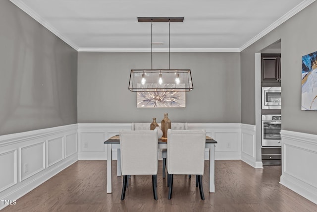 113 Willow View Ln, Apex, NC 27539 - dining area with dark wood-style floors, crown molding, a chandelier, wainscoting, and a decorative wall