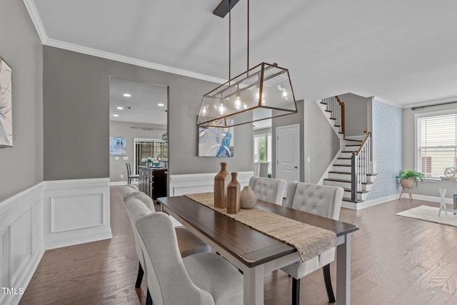 113 Willow View Ln, Apex, NC 27539 - dining room with stairs, ornamental molding, a wainscoted wall, healthy amount of natural light, and wood finished floors