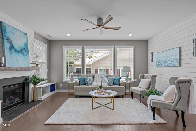 113 Willow View Ln, Apex, NC 27539 - living room with a ceiling fan, wooden walls, recessed lighting, a glass covered fireplace, and wood finished floors
