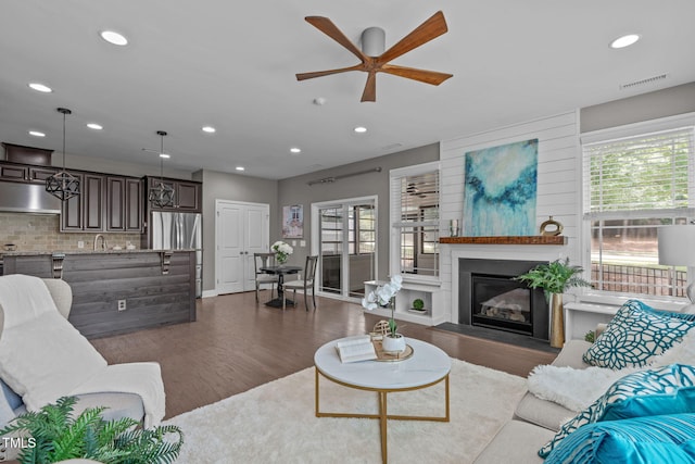 113 Willow View Ln, Apex, NC 27539 - living room featuring dark wood finished floors, a ceiling fan, recessed lighting, and a glass covered fireplace