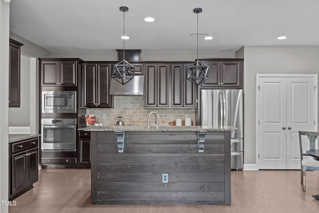113 Willow View Ln, Apex, NC 27539 - kitchen with appliances with stainless steel finishes, extractor fan, dark brown cabinets, wood finished floors, and recessed lighting