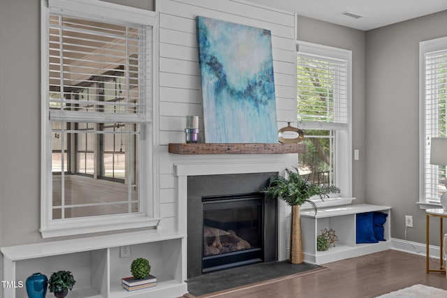 113 Willow View Ln, Apex, NC 27539 - unfurnished living room featuring wood finished floors, a glass covered fireplace, and healthy amount of natural light