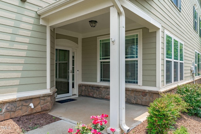 113 Willow View Ln, Apex, NC 27539 - doorway to property featuring covered porch and stone siding