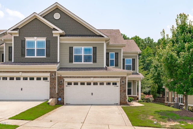 113 Willow View Ln, Apex, NC 27539 - view of front facade featuring a garage, driveway, stone siding, and a front lawn